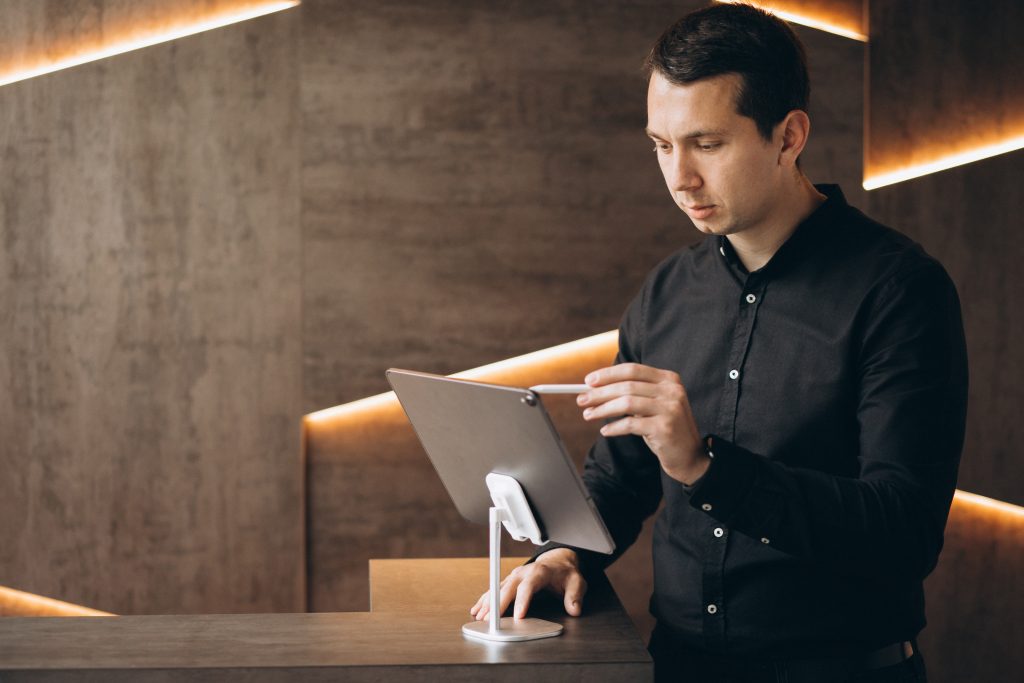 Handsome business man working with tablet in office