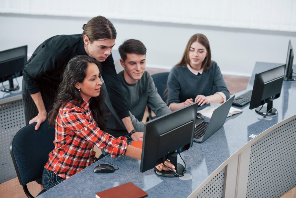 Look at this. Group of young people in casual clothes working in the modern office