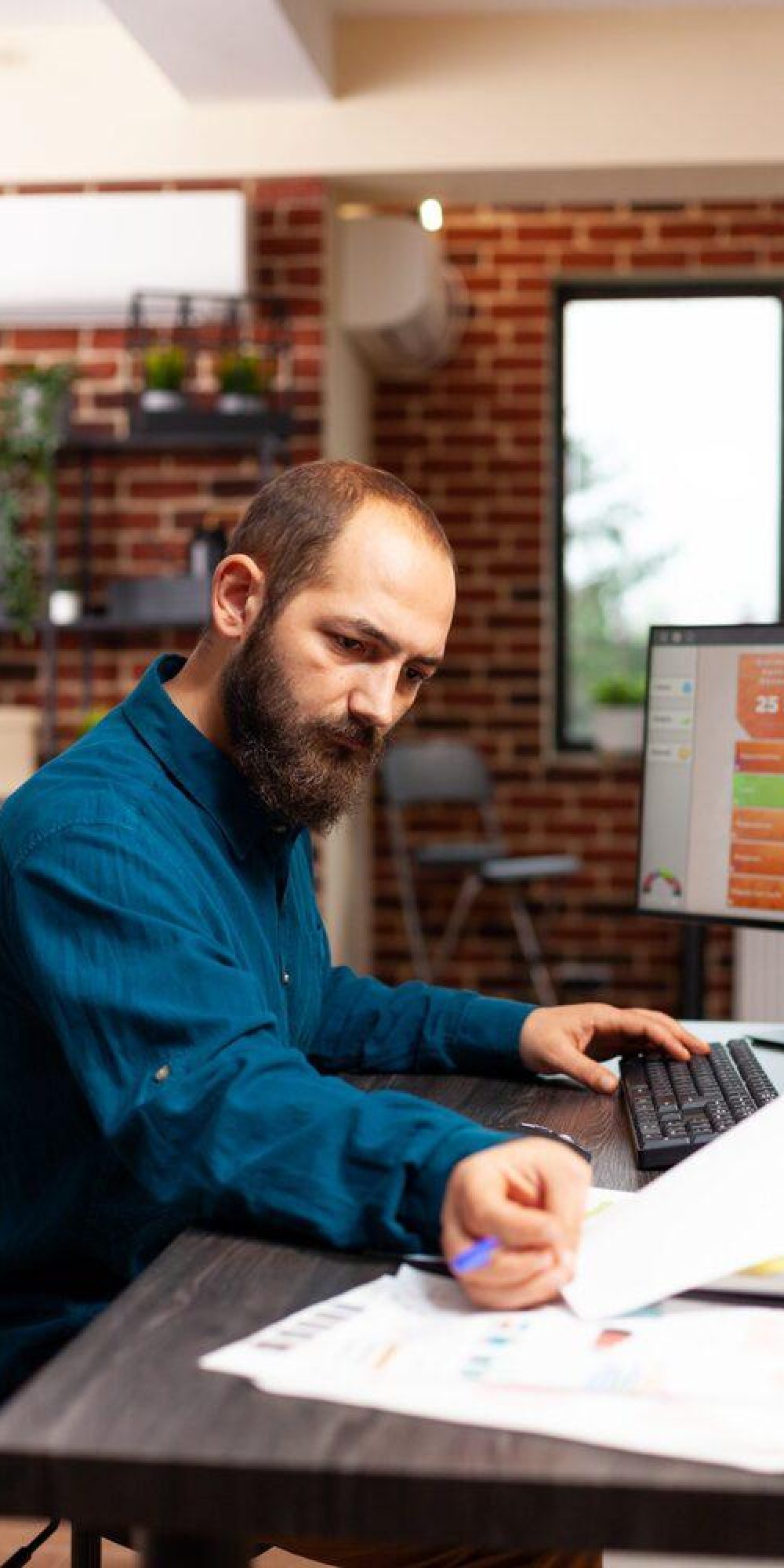 Businessman sitting at desk analyzing business paperwork working at management presentation