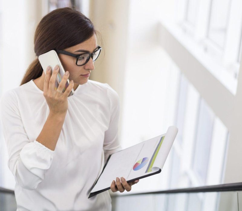 businesswoman-talking-phone-while-escalator