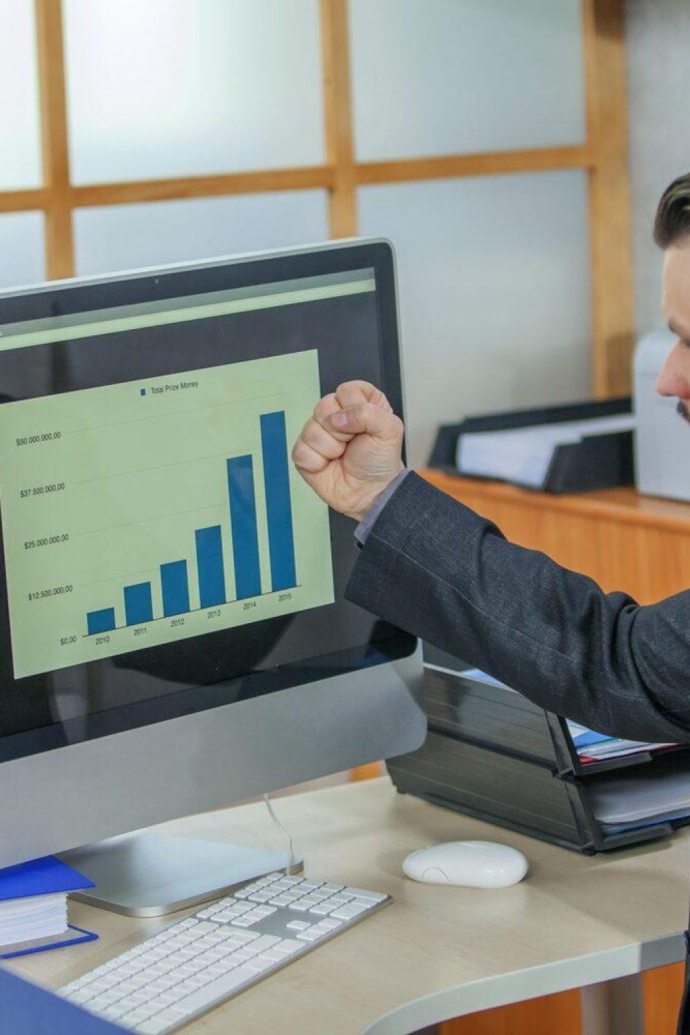 Young businessman working from his office - the concept of success